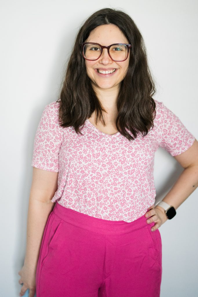 Woman wearing pink floral shirt and bright pink pants